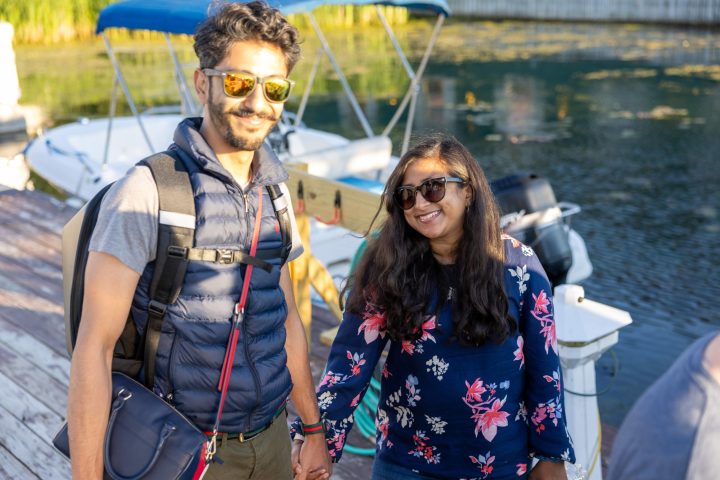 a man and a woman standing in front of water