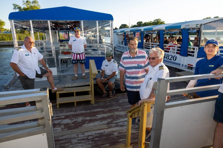 a group of people standing in front of a fence