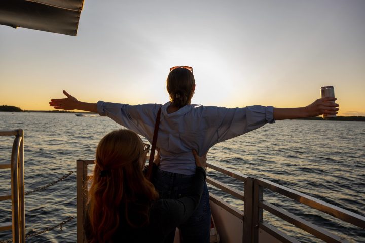 a man standing next to a body of water