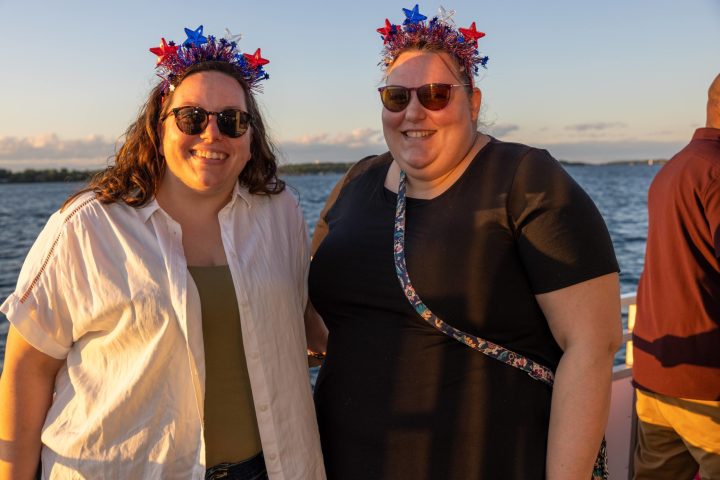 a man and a woman standing next to a body of water