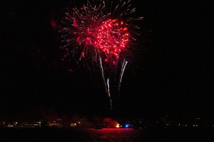 fireworks in the sky over a body of water