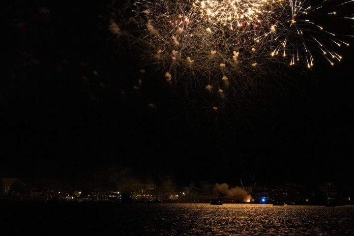 fireworks in the night sky over a body of water