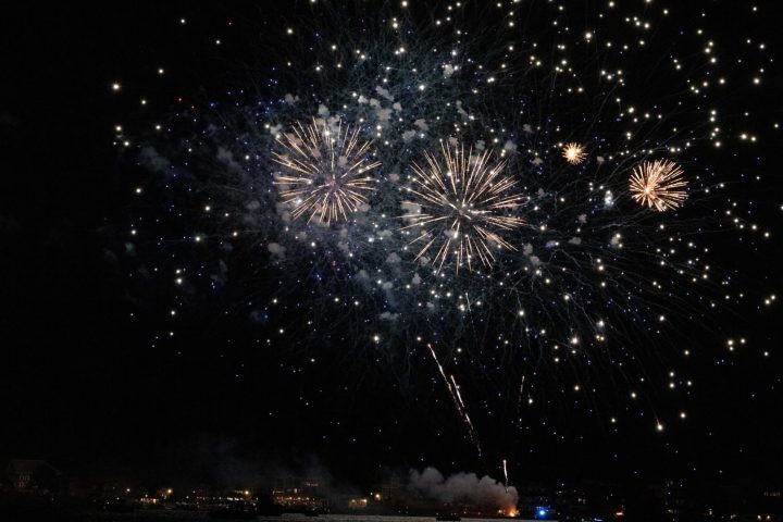 fireworks in the night sky over a body of water