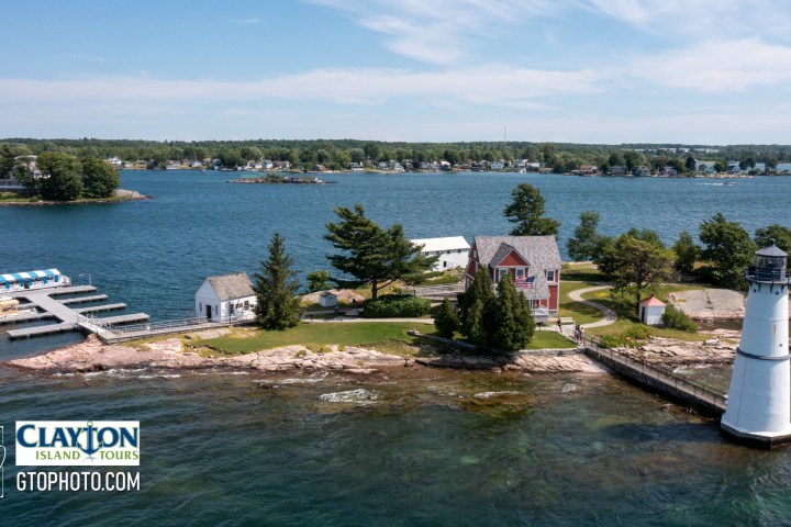 a boat traveling along a river next to a body of water