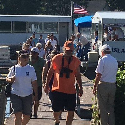 a group of people standing in front of a bus
