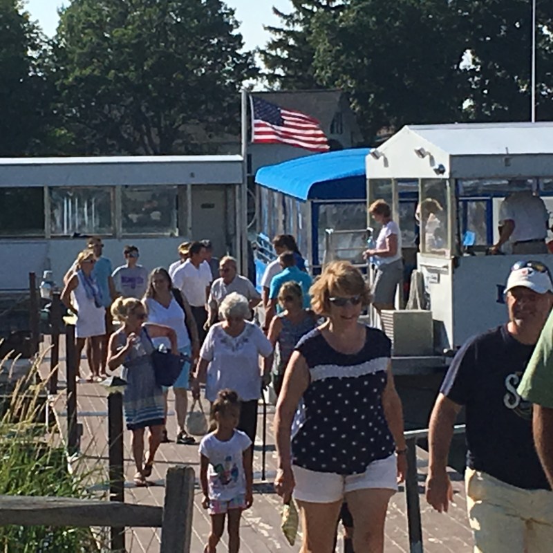a group of people standing in front of a crowd posing for the camera