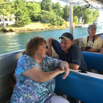 a group of people sitting in front of a body of water