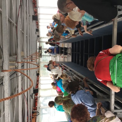 a group of people standing next to a fence
