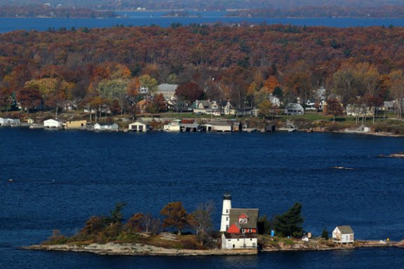 a large body of water with a mountain in the background