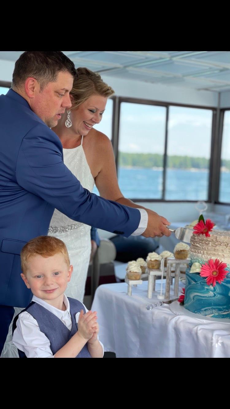 a group of people sitting at a table with a cake