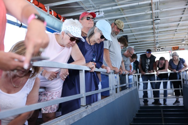 Guests peering through the glass bottom on 