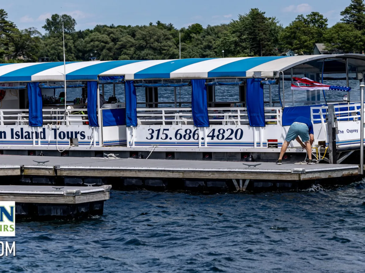 a blue and white boat parked next to a body of water