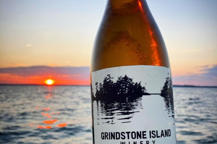 a hand holding a bottle of water