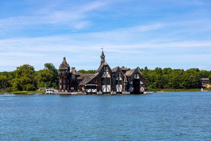 a small clock tower in the middle of a body of water