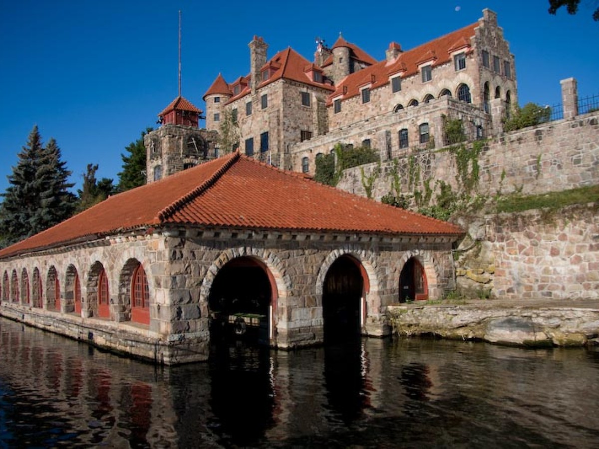 a stone castle next to a brick building