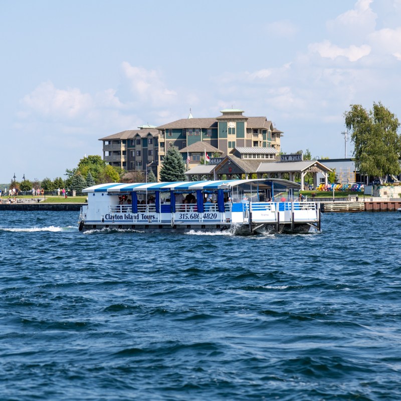 a small boat in a body of water with a city in the background
