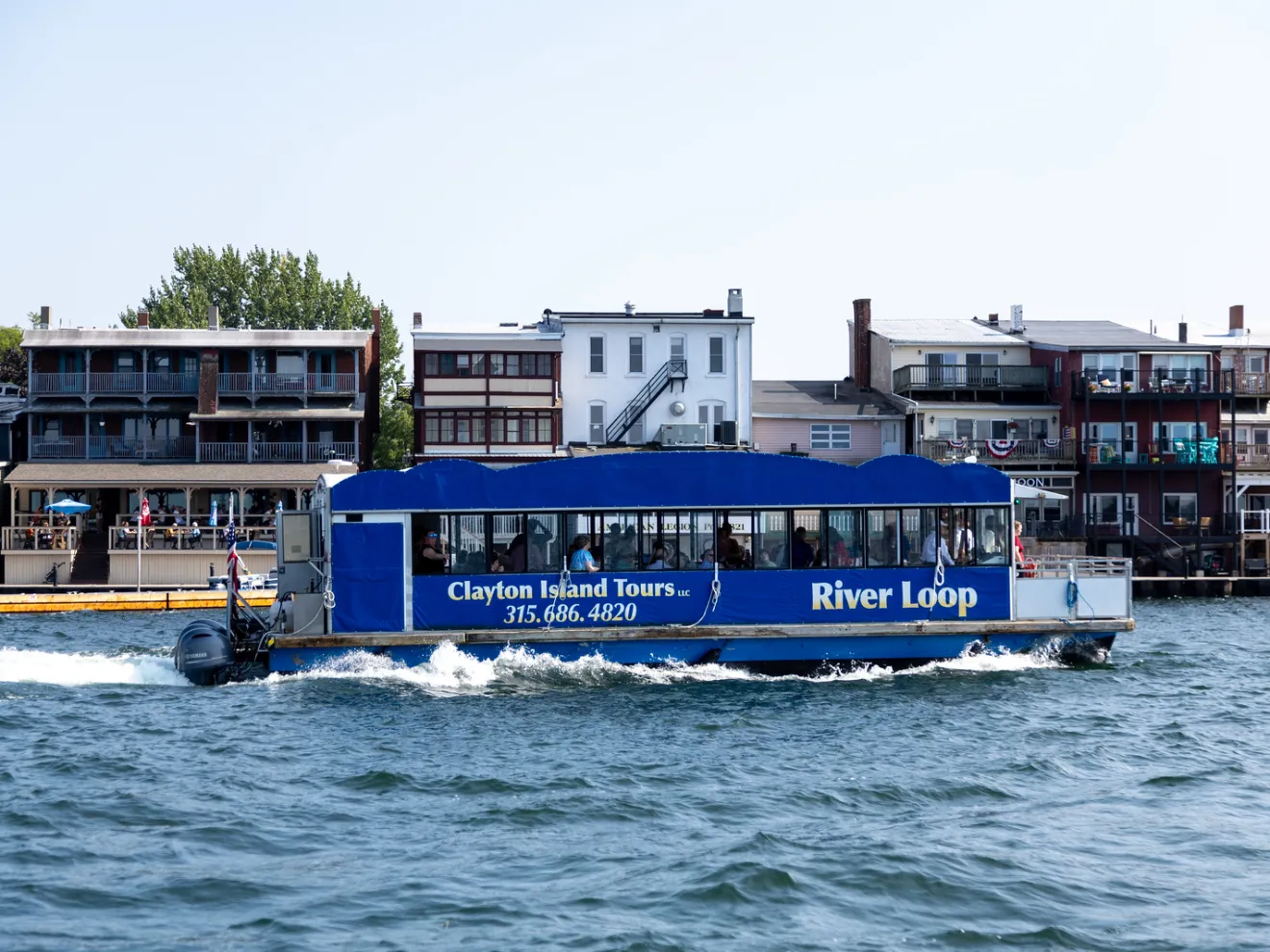 a small boat in a body of water with a city in the background