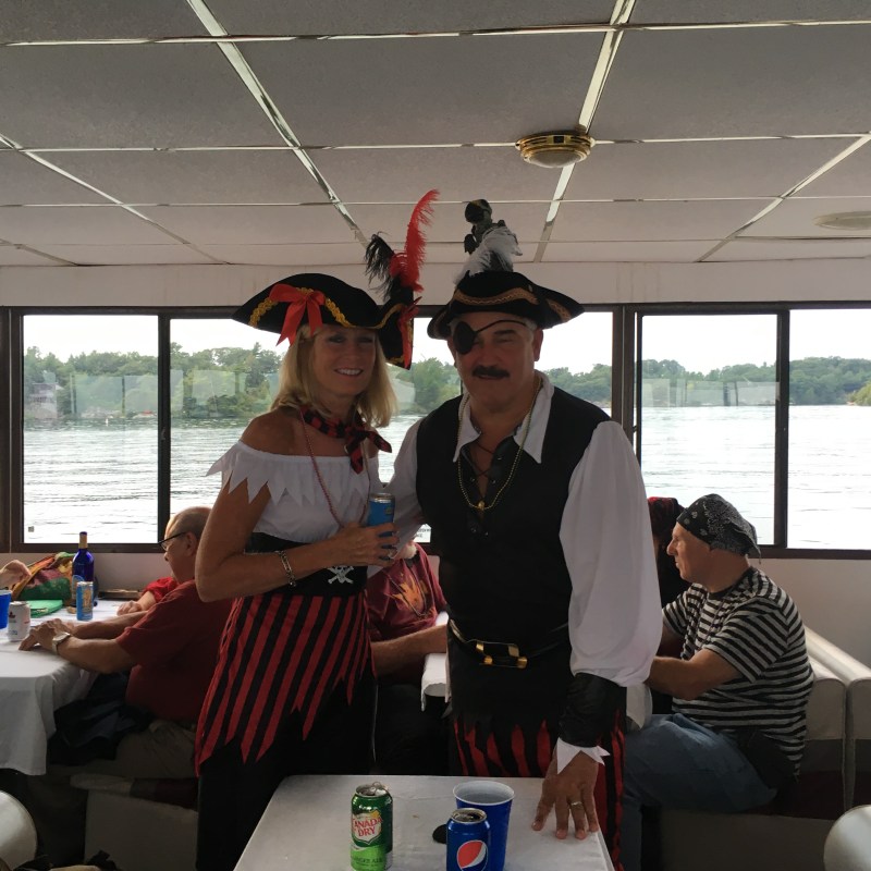 a man and a woman sitting at a table in front of a window